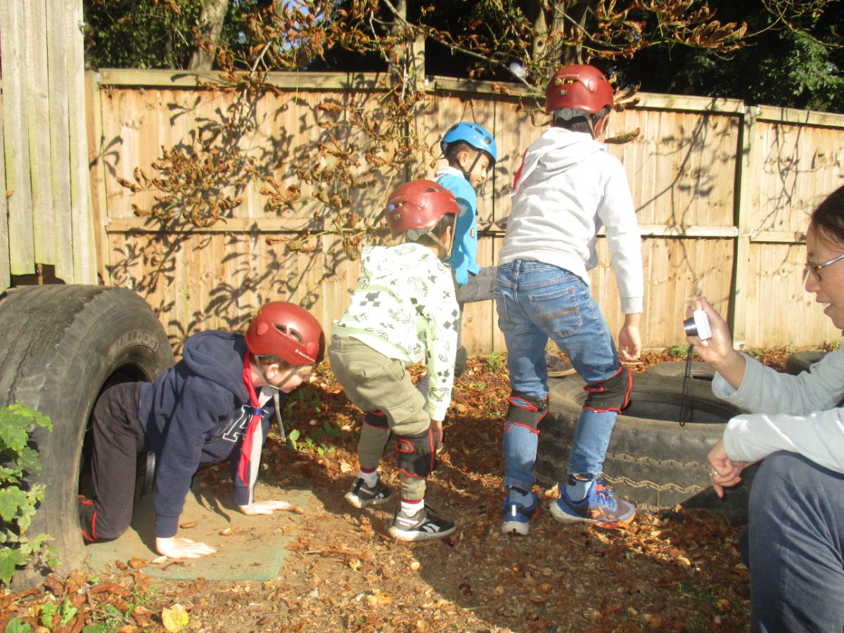 Young people playing outdoors in the autumn leaves