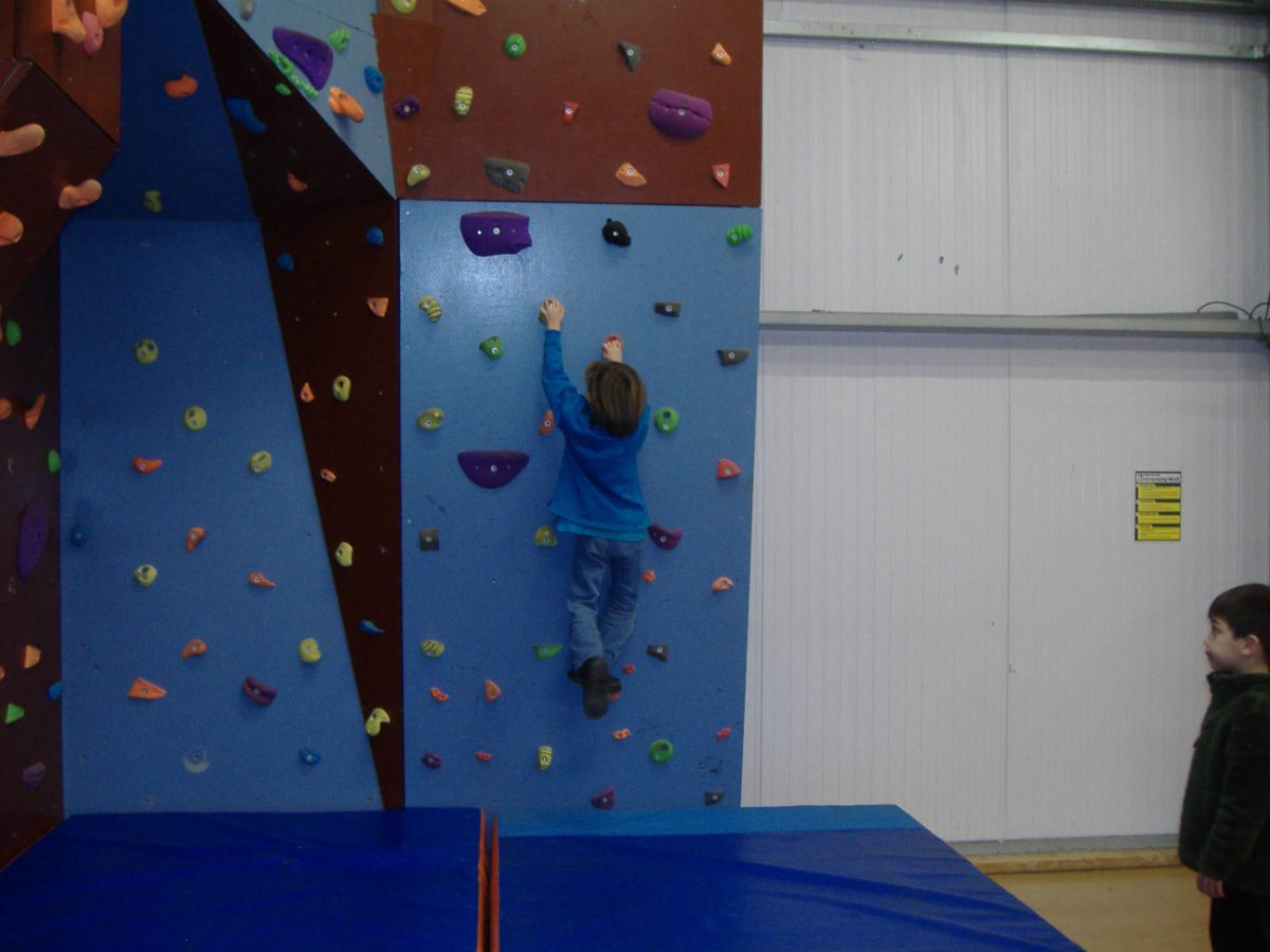 A Scout on the indoor climbing wall